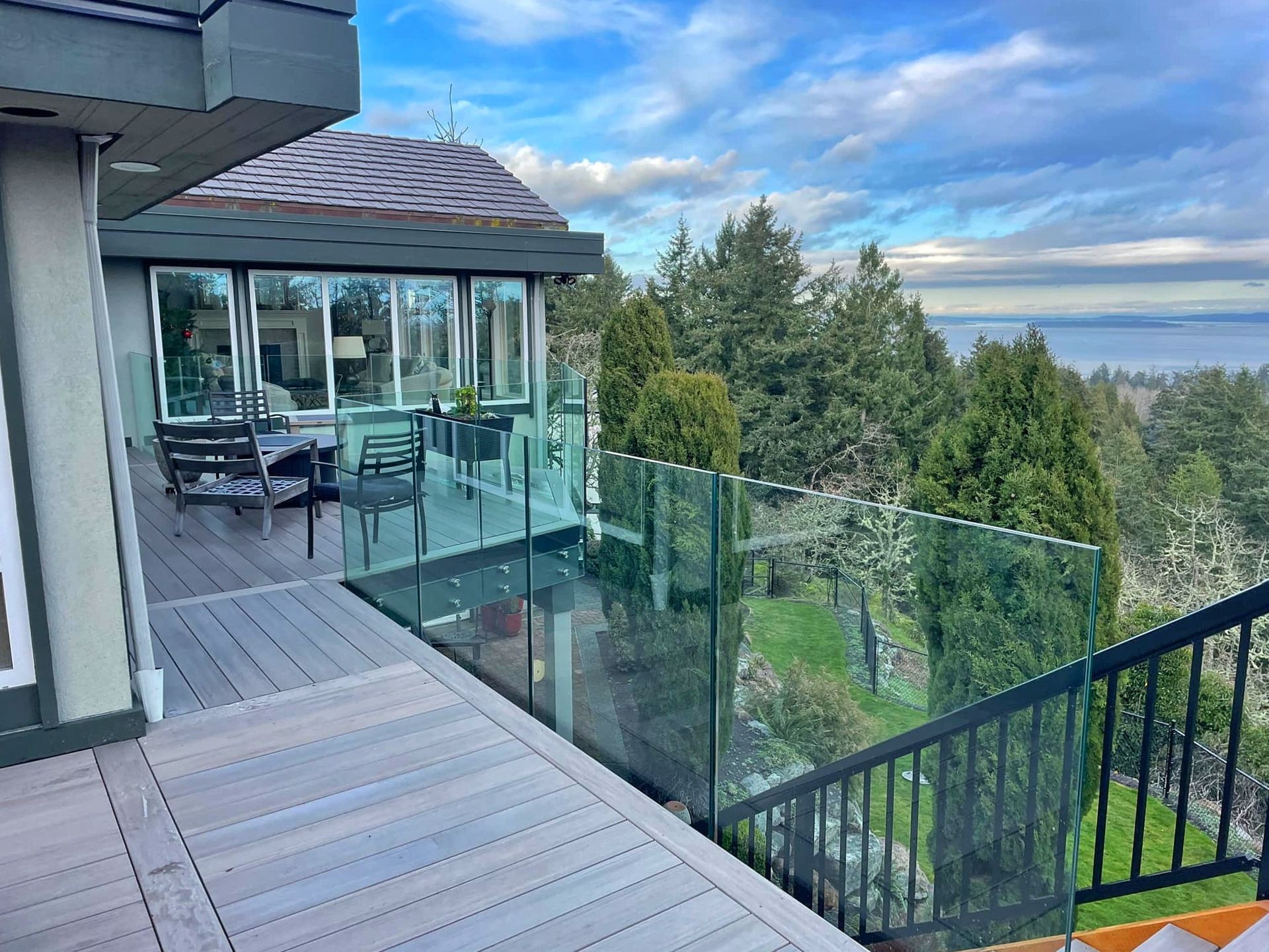 Composite deck with glass railings overlooking the landscape.