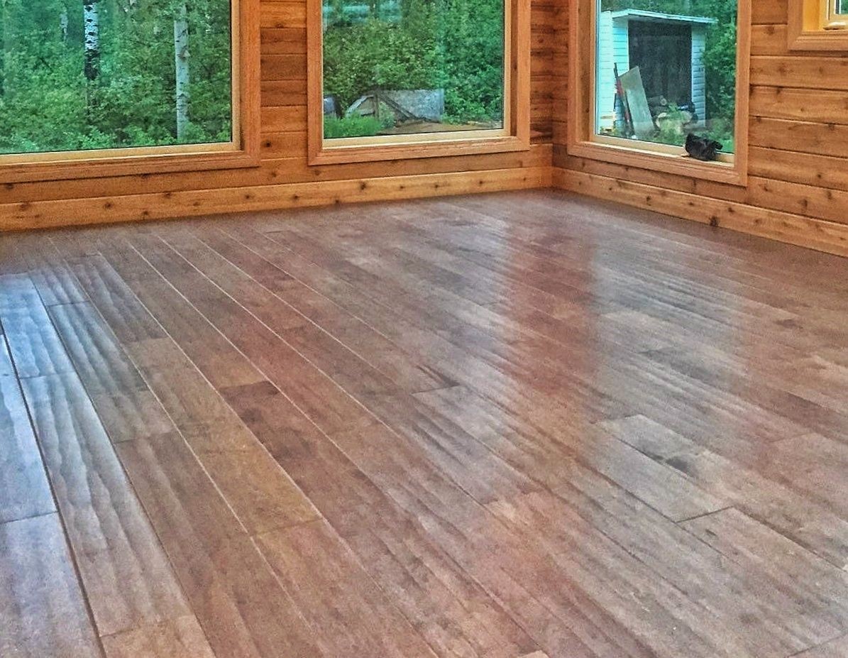 Empty room with medium-brown wood flooring.