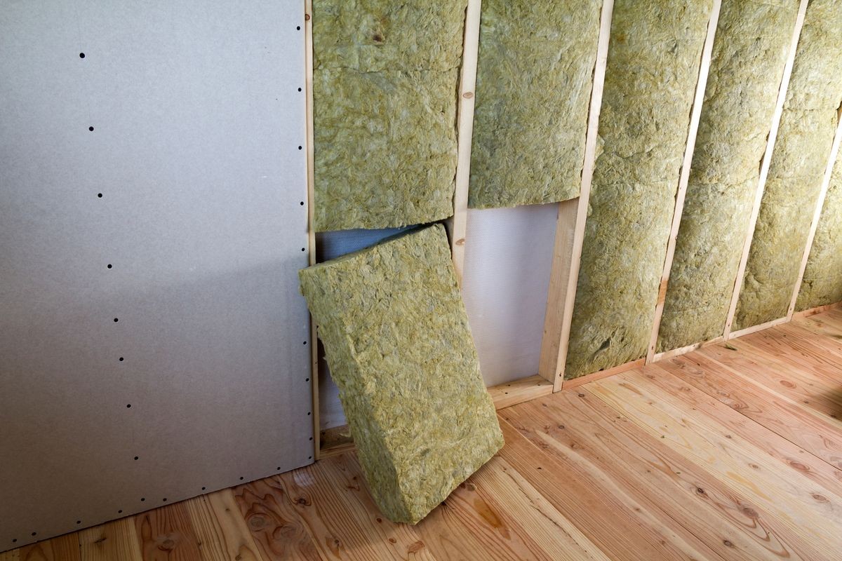 Wooden frame for future walls with drywall plates insulated with rock wool and fiberglass insulation staff for cold barrier. Comfortable warm home, economy, construction and renovation concept.